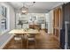 Bright dining area adjacent to a kitchen with white cabinets and stainless steel appliances at 2621 White Oak Dr, Decatur, GA 30032