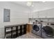 Laundry room featuring modern appliances, built-in sink, and decorative tile floors at 2621 White Oak Dr, Decatur, GA 30032