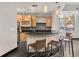 Modern kitchen features stainless steel appliances, custom cabinets, and black countertop with stools and unique backsplash at 89 Mangum Sw St # 119, Atlanta, GA 30313
