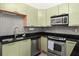 Updated kitchen features stainless steel appliances, grey backsplash and modern cabinets at 89 Mangum Sw St # 119, Atlanta, GA 30313