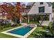 Stunning pool and backyard with well-manicured lawn and landscaping, including a vibrant red maple tree at 96 The Prado Ne, Atlanta, GA 30309