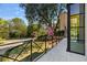 Spacious stone balcony overlooking a professionally landscaped yard with mature trees and blooming shrubs, perfect for relaxing outdoors at 96 The Prado Ne, Atlanta, GA 30309