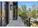 Stylish home featuring a balcony with black iron railings and a view of lush greenery at 96 The Prado Ne, Atlanta, GA 30309