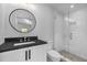 Modern bathroom features a round mirror, granite countertop, and glass-enclosed shower at 96 The Prado Ne, Atlanta, GA 30309