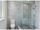 Modern bathroom with tiled walls, a glass shower, and natural light from a window at 96 The Prado Ne, Atlanta, GA 30309