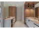 Elegant bathroom featuring double vanities, wood cabinetry, and modern lighting fixtures at 96 The Prado Ne, Atlanta, GA 30309