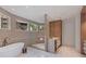 Bright bathroom with modern tub and shower, featuring double vanities, contemporary fixtures and lighting at 96 The Prado Ne, Atlanta, GA 30309
