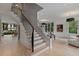 Bright foyer featuring hardwood floors, a staircase with iron railings, and large windows at 96 The Prado Ne, Atlanta, GA 30309