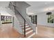 Bright foyer featuring hardwood floors, a staircase with iron railings, and large windows at 96 The Prado Ne, Atlanta, GA 30309