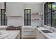Bright kitchen with white cabinets, marble countertops, stainless steel appliances, and tile backsplash at 96 The Prado Ne, Atlanta, GA 30309