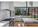 Gourmet kitchen with marble counters, professional appliances, and large windows overlooking the backyard at 96 The Prado Ne, Atlanta, GA 30309