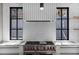 The kitchen features a gas range with stainless steel appliances, custom hood, and marble countertops at 96 The Prado Ne, Atlanta, GA 30309