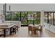 Open concept living room and kitchen area, with large glass doors offering a view of the landscaped yard at 96 The Prado Ne, Atlanta, GA 30309