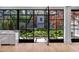 Bright living room with indoor outdoor access through steel doors, a view of the landscape, and garden at 96 The Prado Ne, Atlanta, GA 30309