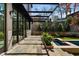 Elegant stone patio with black metal pergola next to pool and beautifully landscaped plantings offer perfect outdoor relaxation space at 96 The Prado Ne, Atlanta, GA 30309