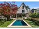 Beautiful in-ground swimming pool with stone surround complemented by lush green lawn and sophisticated landscaping provides perfect relaxation at 96 The Prado Ne, Atlanta, GA 30309