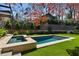 Inviting backyard featuring a pristine pool and spa combination, surrounded by lush green grass and professional landscaping at 96 The Prado Ne, Atlanta, GA 30309