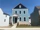Charming two-story home with light-blue siding, black trim, white framed windows, and a welcoming front porch at 2717 Creek View Nw Ter, Atlanta, GA 30318