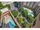 Aerial view of the neighborhood featuring swimming pools and lush greenery at 3286 Northside Nw Pkwy # 1007, Atlanta, GA 30327