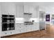 Modern kitchen equipped with stainless steel appliances, white cabinets, and stylish backsplash at 3286 Northside Nw Pkwy # 1007, Atlanta, GA 30327