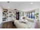 Bright living room with hardwood floors, built-in bookshelves, and a private balcony with city views at 3286 Northside Nw Pkwy # 1007, Atlanta, GA 30327