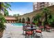 Beautiful community pool area with tables, chairs, and lush landscaping at 3286 Northside Nw Pkwy # 1007, Atlanta, GA 30327
