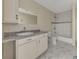 Bathroom with vanity, granite countertop, and tiled shower/tub, providing a clean design at 3635 Spring Mesa Dr, Snellville, GA 30039