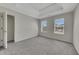 Bedroom with a tray ceiling, carpet, and natural light coming in through two windows at 3635 Spring Mesa Dr, Snellville, GA 30039