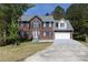 Charming two-story brick home with attached garage, a well-maintained lawn, and traditional architectural design at 3635 Spring Mesa Dr, Snellville, GA 30039