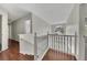 Second floor hallway with wooden banister and engineered hardwood flooring at 3635 Spring Mesa Dr, Snellville, GA 30039