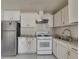 Kitchen with white cabinets, granite countertops, stainless steel appliances and tile backsplash at 3635 Spring Mesa Dr, Snellville, GA 30039