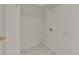 Laundry room with white walls, tile flooring, and wire rack shelving at 3635 Spring Mesa Dr, Snellville, GA 30039