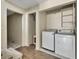 Convenient laundry room with modern washer and dryer, storage shelves, and tile accents at 3635 Spring Mesa Dr, Snellville, GA 30039