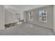 Bright living room with staircase, plush carpet, neutral walls, and large windows at 3635 Spring Mesa Dr, Snellville, GA 30039