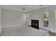 Cozy living room features a fireplace, ceiling fan, carpet, and a door to the outside at 3635 Spring Mesa Dr, Snellville, GA 30039