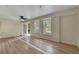 Bright living room features wood floors, modern ceiling fan, and French door access to the outside at 3635 Spring Mesa Dr, Snellville, GA 30039