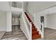 Elegant staircase with wood steps and white railing, leading to the upper level at 3635 Spring Mesa Dr, Snellville, GA 30039