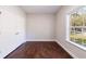 A bedroom features wood floors, natural light, and a closet at 6490 Lake Esther Dr, Fairburn, GA 30213