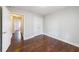 Bedroom with hardwood floors and an open door to the hallway at 6490 Lake Esther Dr, Fairburn, GA 30213