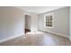 Sunlit bedroom featuring an open door and view from window at 6490 Lake Esther Dr, Fairburn, GA 30213
