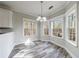 Cozy breakfast nook with natural light provided by three windows and stylish gray-toned flooring at 6490 Lake Esther Dr, Fairburn, GA 30213