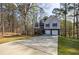 Traditional home with a long driveway and wooded surroundings, offering a sense of privacy at 6490 Lake Esther Dr, Fairburn, GA 30213