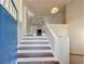 Inviting foyer with hardwood stairs leading to a spacious living area, seen from the front door at 6490 Lake Esther Dr, Fairburn, GA 30213