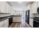 Spacious kitchen with white cabinetry, wood-look floors, stainless steel appliances, and a breakfast nook at 6490 Lake Esther Dr, Fairburn, GA 30213
