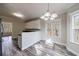 Bright kitchen with white cabinetry, wood-look floors, stainless steel appliances, and a modern pendant light at 6490 Lake Esther Dr, Fairburn, GA 30213