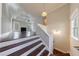 View of the living room from the top of the entry stairs, showcasing an open concept space at 6490 Lake Esther Dr, Fairburn, GA 30213