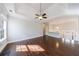 Bright living room boasts hardwood floors, trey ceiling, a fireplace, recessed lights, and windows at 6490 Lake Esther Dr, Fairburn, GA 30213