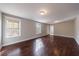 Spacious living room featuring hardwood floors, neutral paint, and natural light at 6490 Lake Esther Dr, Fairburn, GA 30213