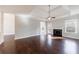 Open-concept living room with hardwood floors, fireplace, and a door leading to the outdoors at 6490 Lake Esther Dr, Fairburn, GA 30213