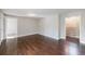 Spacious living room with hardwood floors and a staircase, perfect for entertaining at 6490 Lake Esther Dr, Fairburn, GA 30213